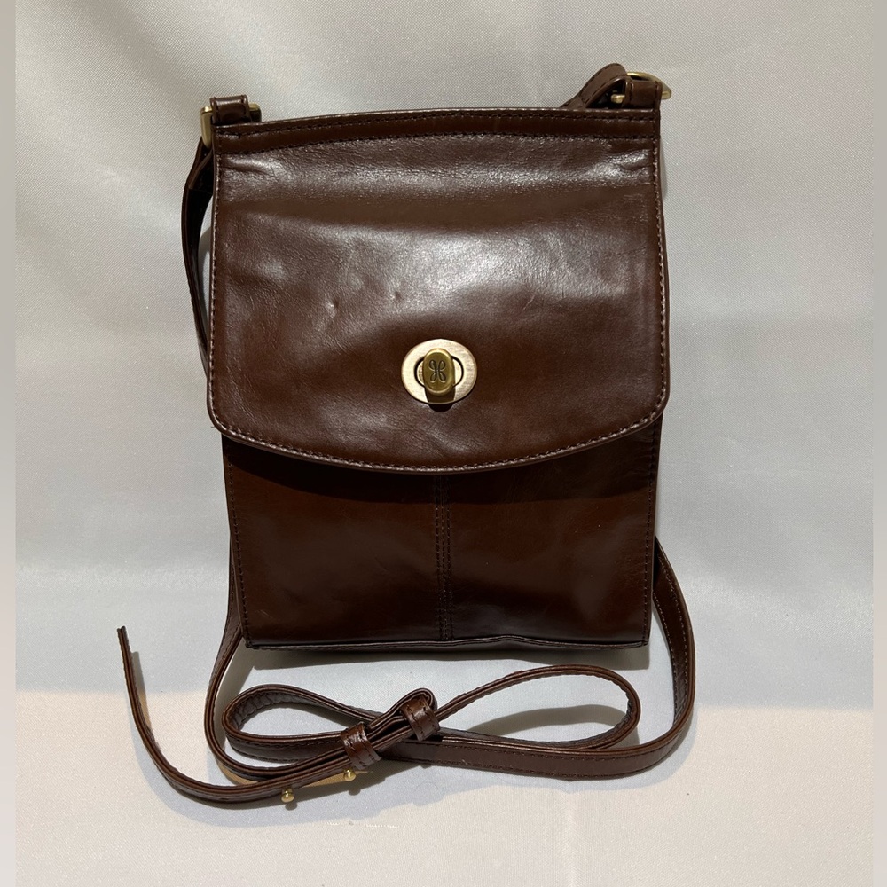 HOBO 9 1/2 x 7 brown leather with flap closure. Adjustable strap crossbody purse